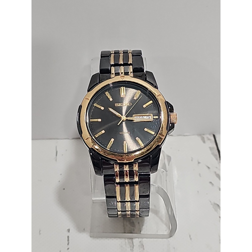 Seiko Quartz 100M watch (black and gold two-tone with day/date)